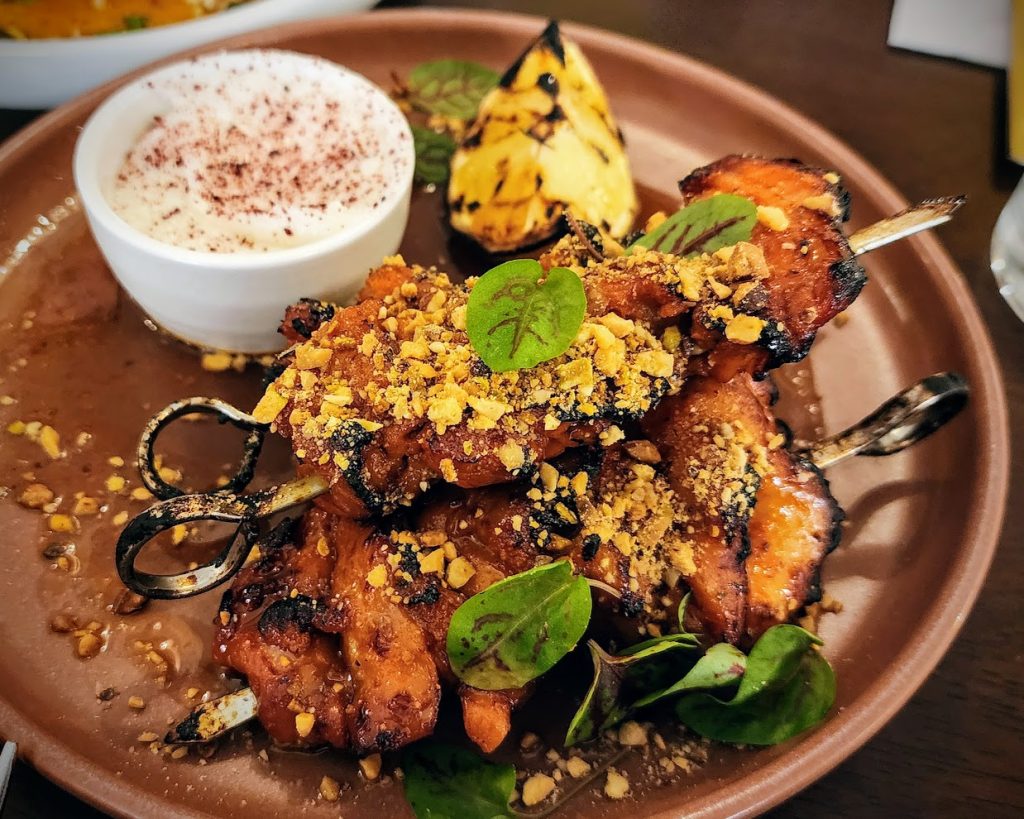 Baklawa Chicken Bites - roasted chicken skewers, spiced honey, mixed nuts